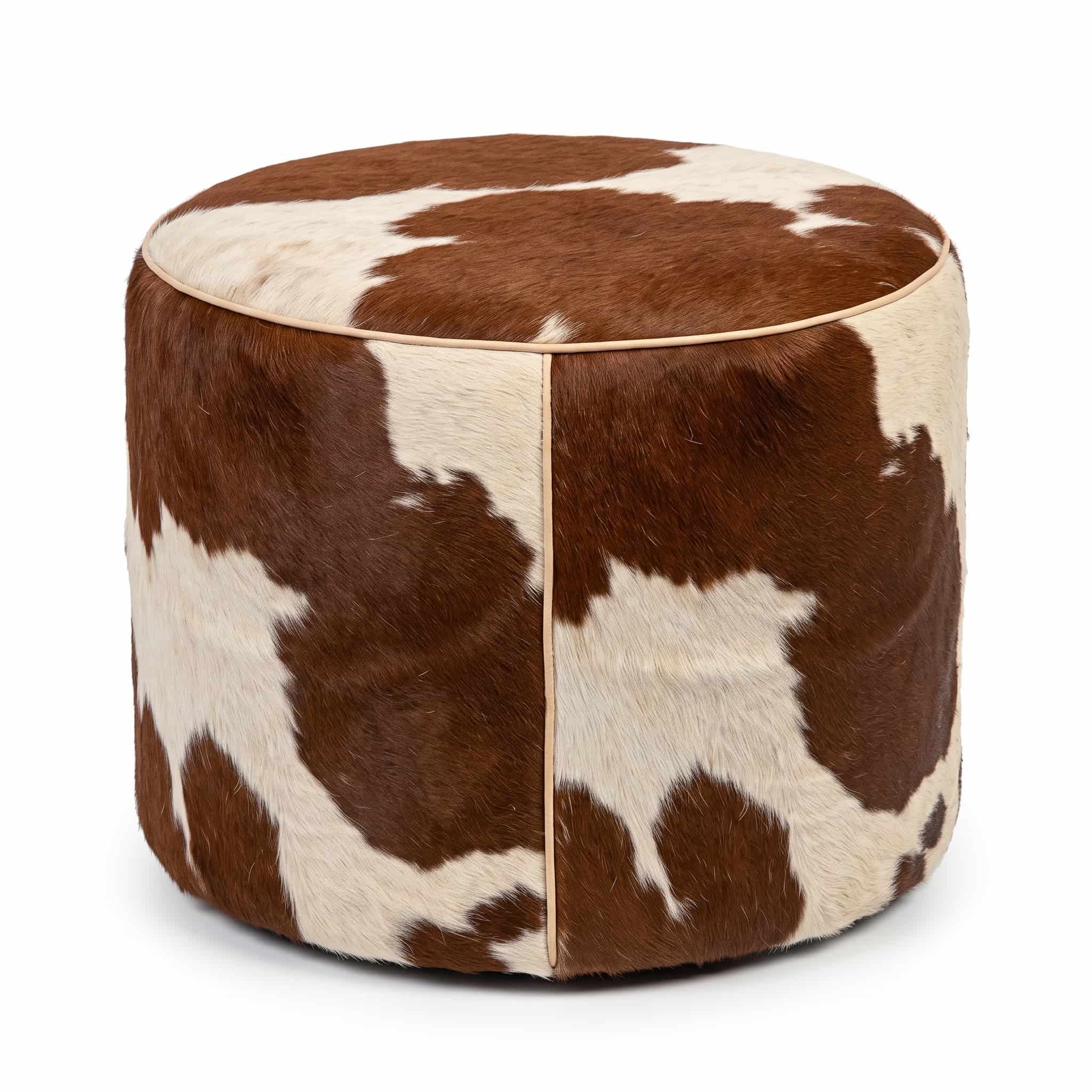 cowhide-ottoman-brown-white-round-drum-pouf Brown and white cowhide ottoman, round hair-on-hide drum pouf with leather piping, on white background