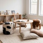 Black & white and brown & white cowhide ottomans as seats around a low table in a children’s reading corner