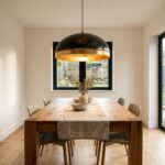 Large gold leaf dome pendant light hanging over an oak dining table
