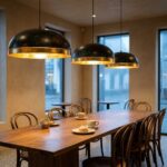 Gold leaf copper dome pendant lights over a long café table