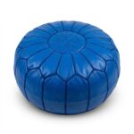 Royal blue leather pouf, round goatskin ottoman with tonal embroidered star on white background